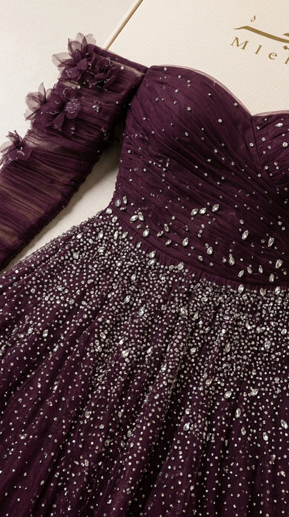 Close-up detail of ruched sweetheart bodice, beadwork, and 3D floral accents
