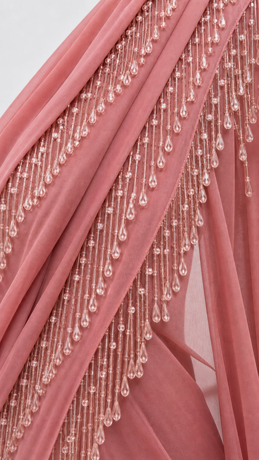 Close-up detail of tiered beaded tassel trim on draped fabric