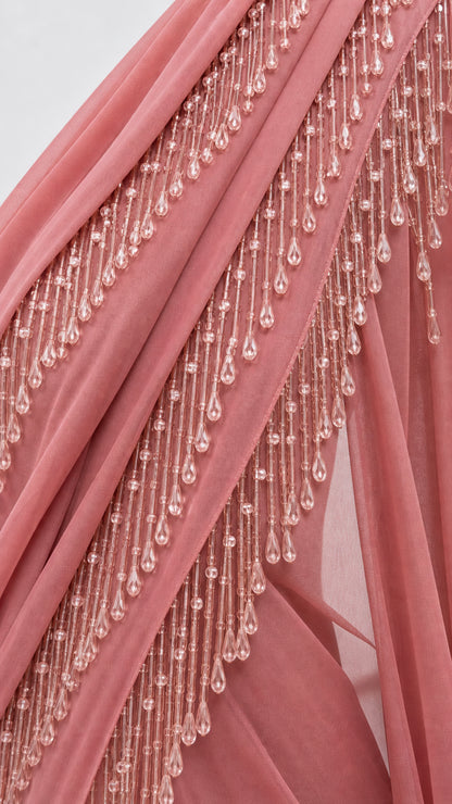 Close-up detail of tiered beaded tassel trim on draped fabric