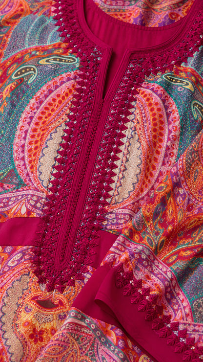 Close-up of intricate embroidered lace neckline trim on Fuchsia kaftan