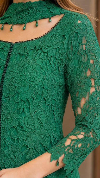 Close-up detail of emerald green floral lace, beaded trim, and matching lace neck accessory