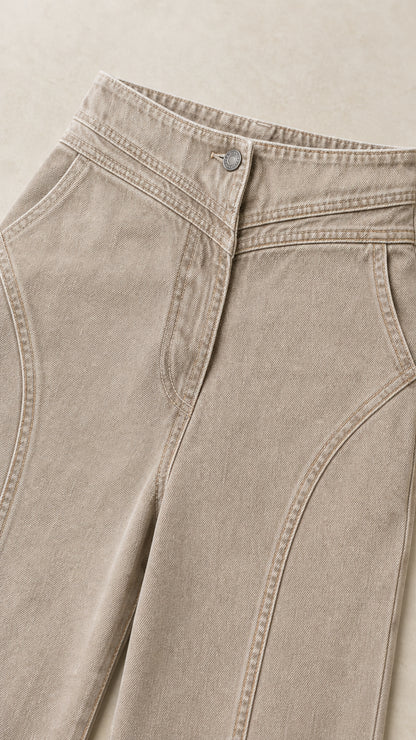 Close-up detail of high waistband, button closure, and curved yoke seams