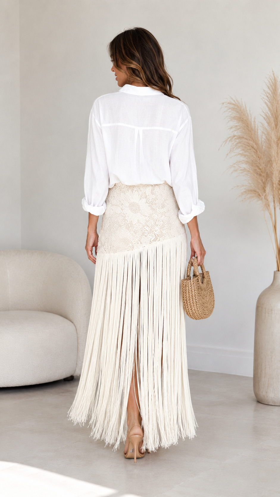 Back view of ivory fringe maxi skirt showing flowing full-length fringe