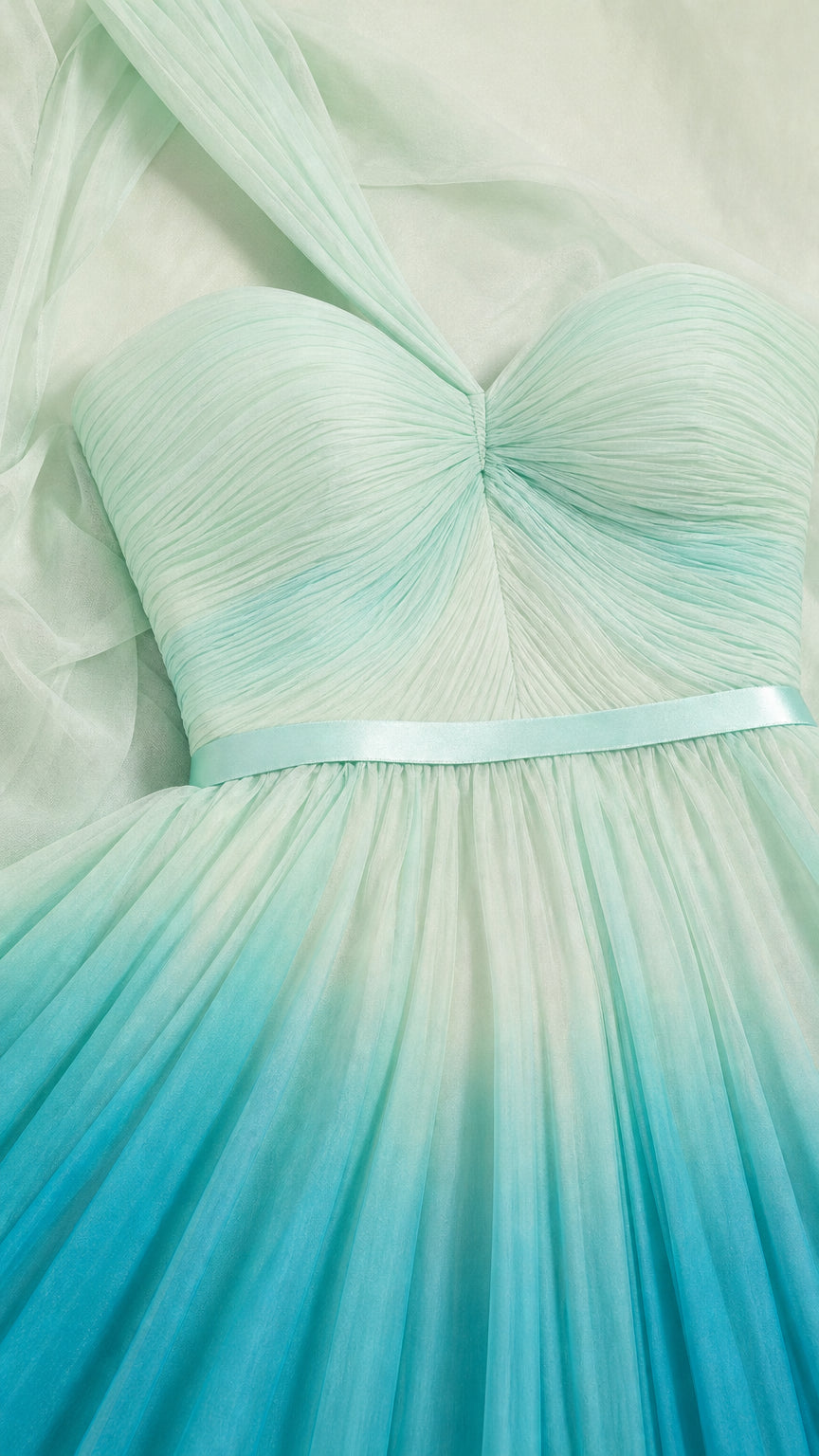 Close-up detail of pleated sweetheart bodice and mint-to-teal chiffon fabric
