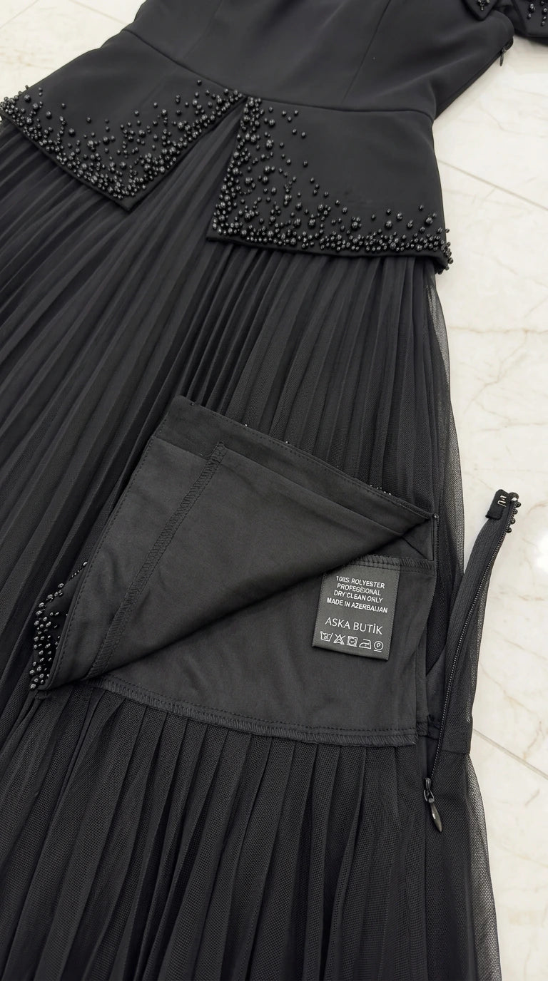 Close-up detail of beaded waist overlay and zipper construction