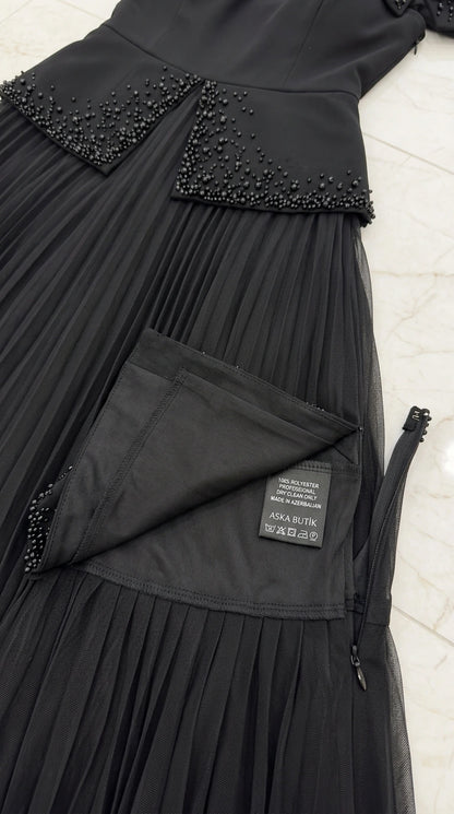 Close-up detail of beaded waist overlay and zipper construction