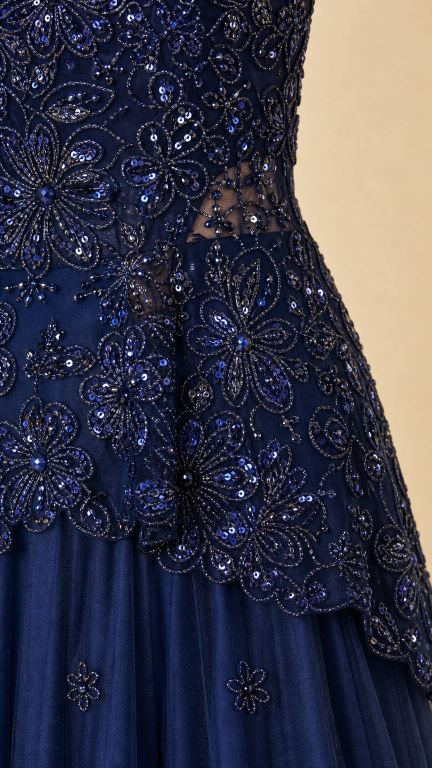 Detailed close-up of navy blue sequin and floral beadwork on bodice and peplum