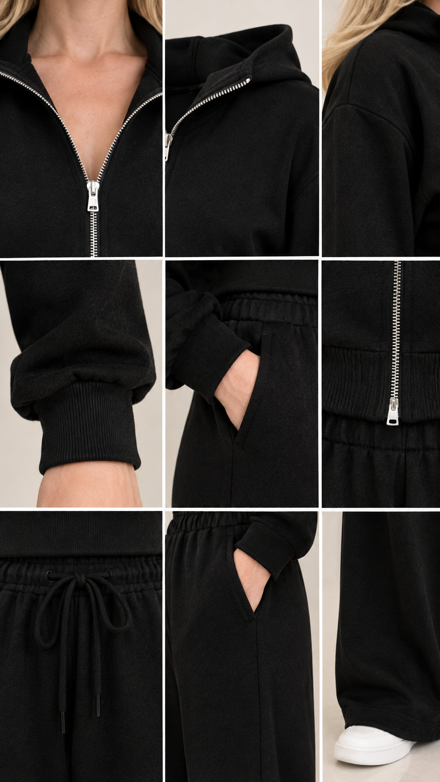 Close-up details of black tracksuit zipper collar ribbed cuffs and drawstring waistband