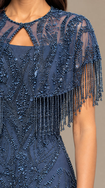 Close-up detail of beaded sheer capelet overlay with fringe trim and keyhole neckline