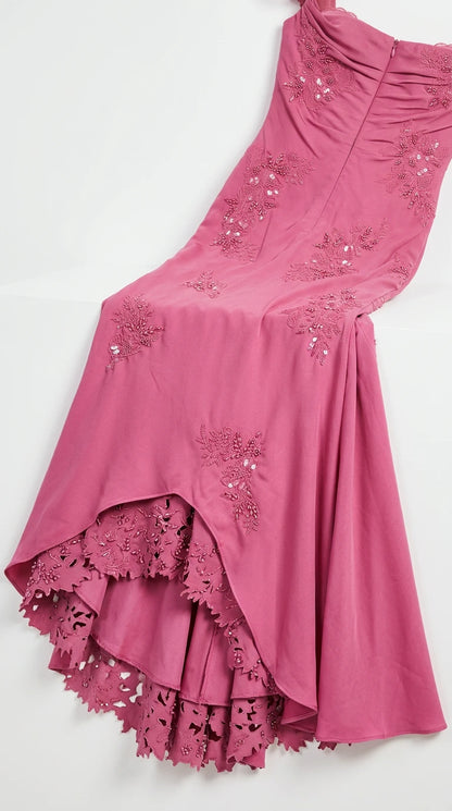 Close-up detail of embroidered fabric and scalloped lace hem