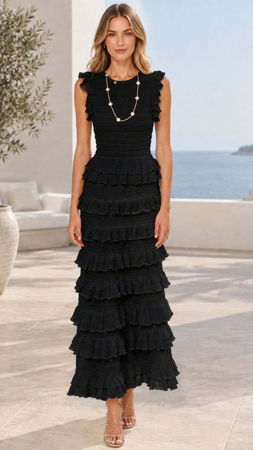 Model wearing black sleeveless tiered ruffle maxi dress