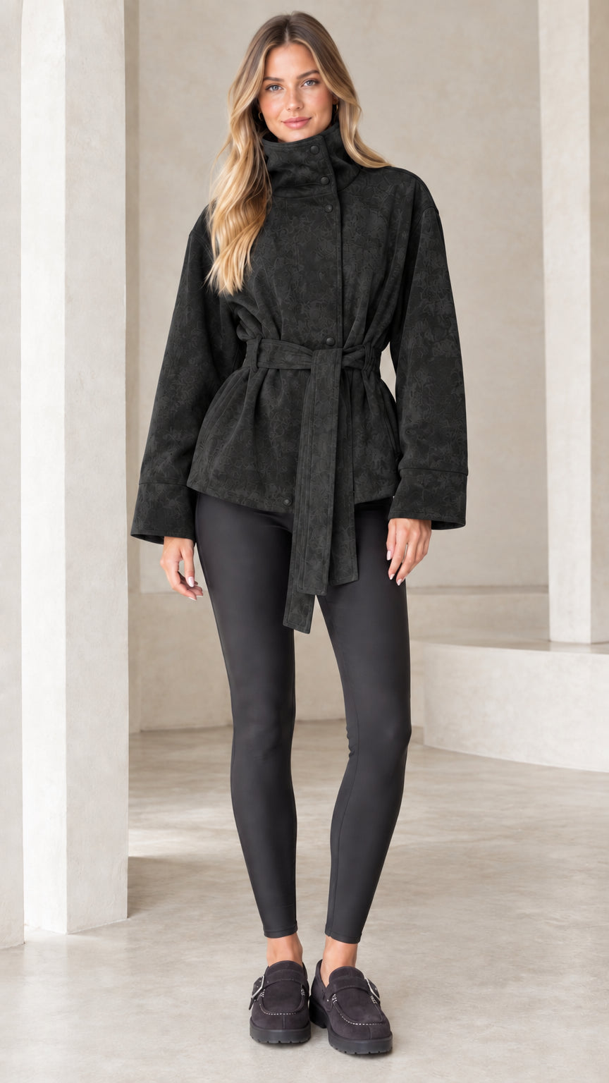 Model wearing black high-neck belted faux suede jacket