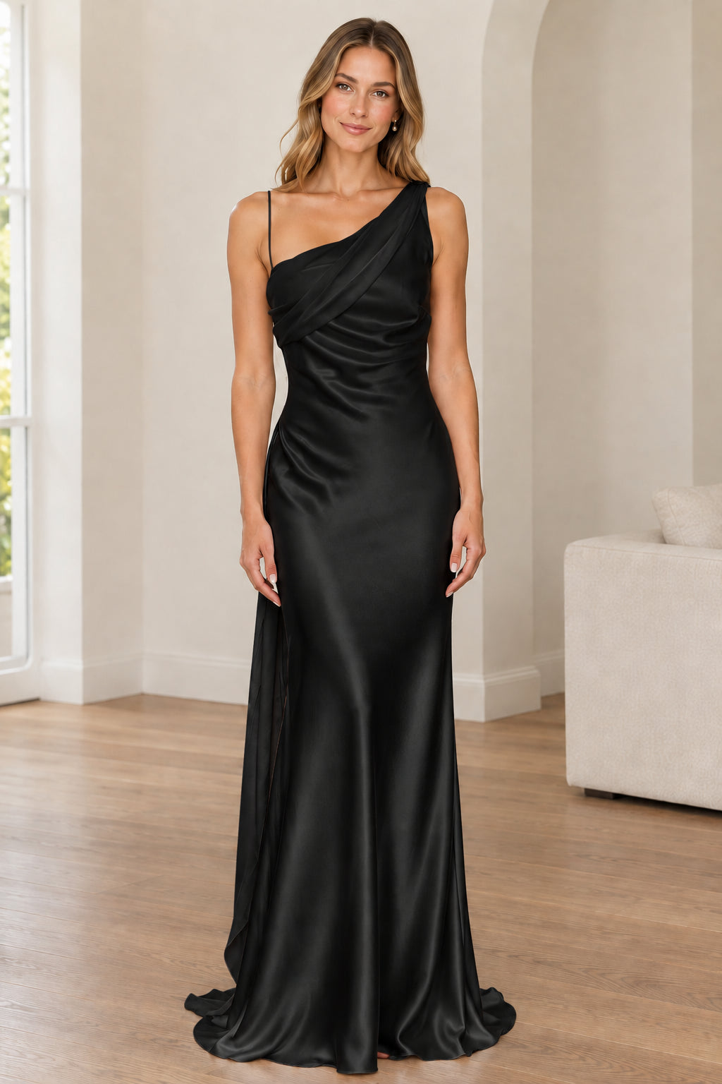 Front full-length view of woman in black one-shoulder satin evening gown