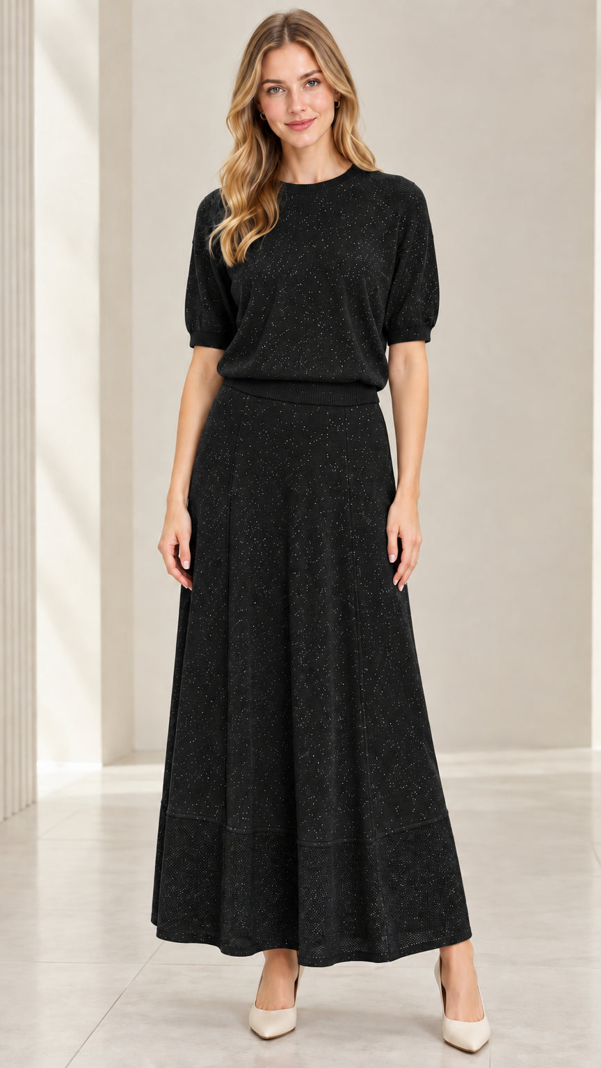 Model wearing black shimmer short sleeve knit top and matching maxi skirt set