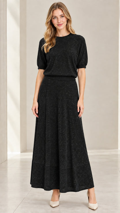 Model wearing black shimmer short sleeve knit top and matching maxi skirt set