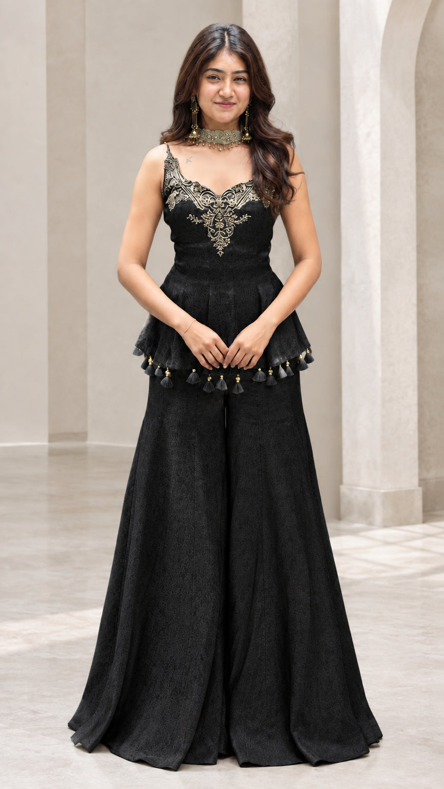 Front view of woman wearing black embroidered peplum sharara pants set