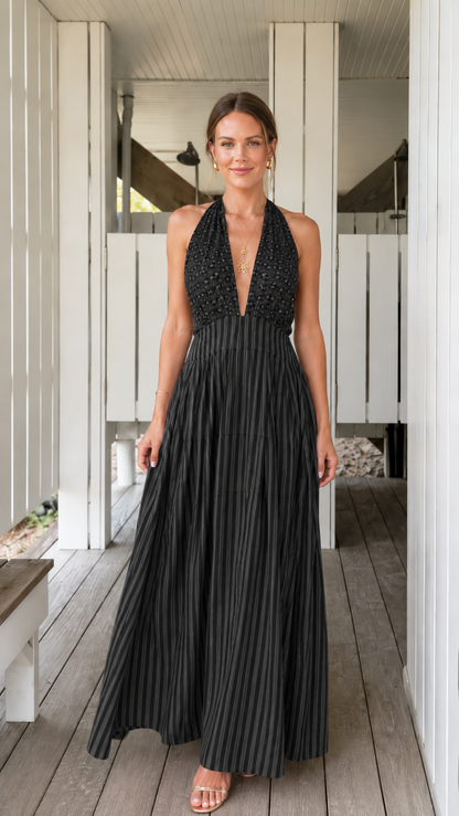 Front view of black pleated halter backless maxi dress