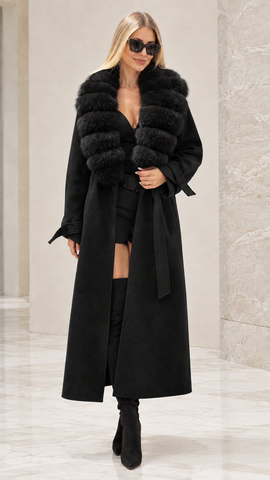 Front full view of woman wearing black maxi trench coat with black faux fur collar