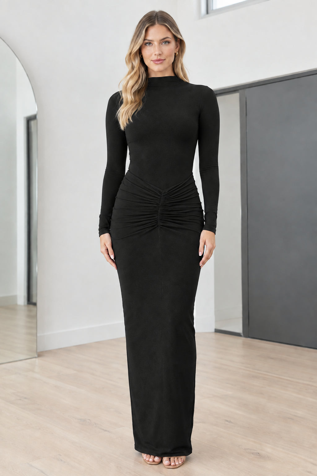 Full front view of model wearing Black mock neck long sleeve ruched maxi dress