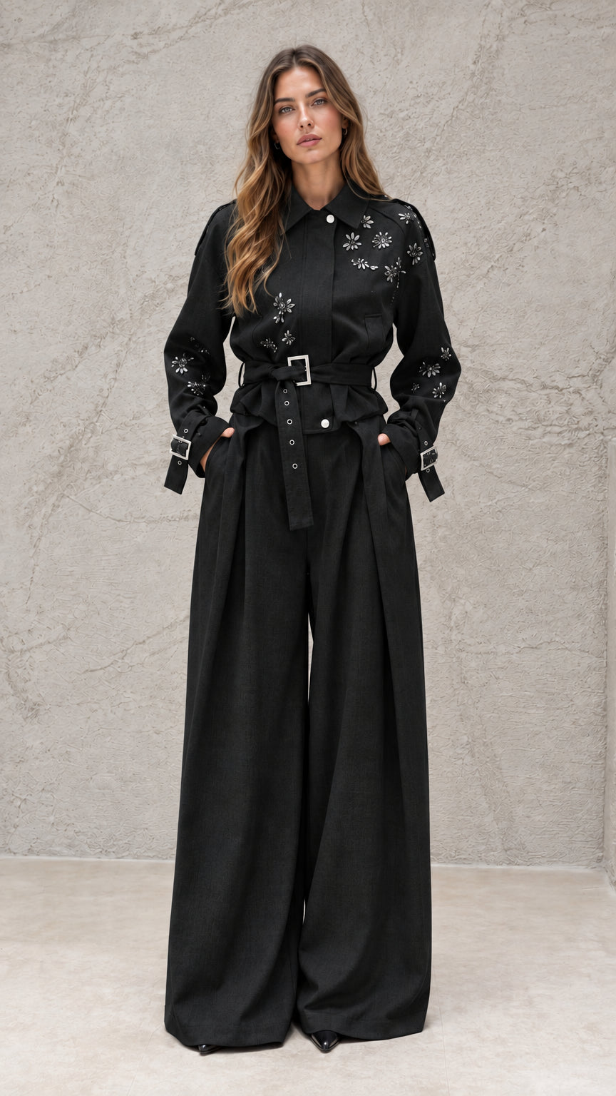 Full front view of model wearing black embellished wide-leg jumpsuit