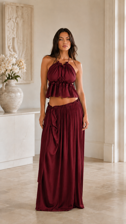 Front view of burgundy halter crop top and maxi skirt two-piece set