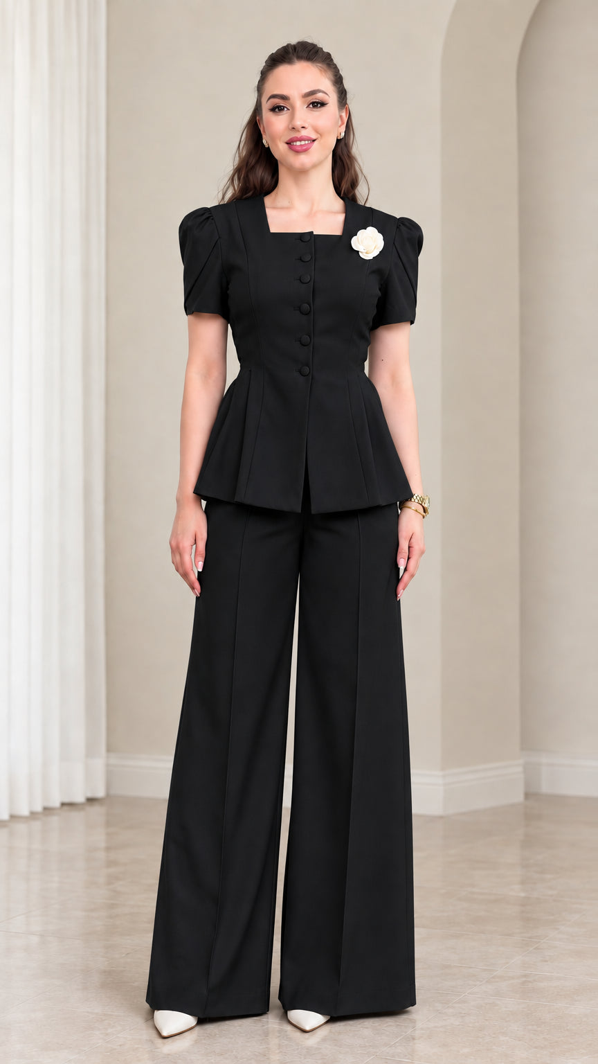 Model wearing Black two-piece peplum top and wide leg trousers set