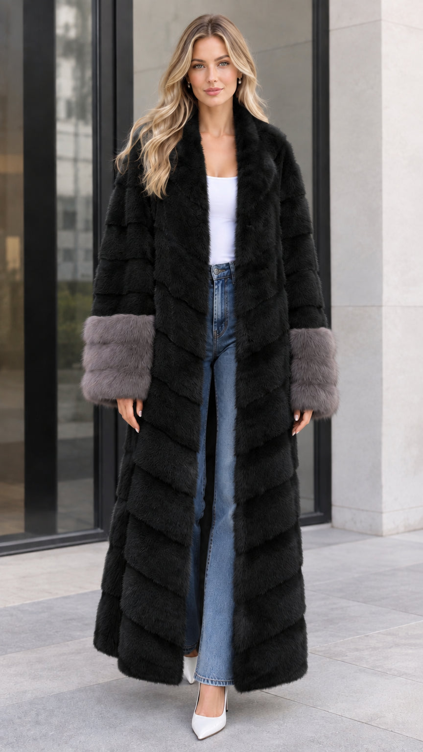 Front view of women's black chevron maxi faux fur coat with contrast grey cuffs