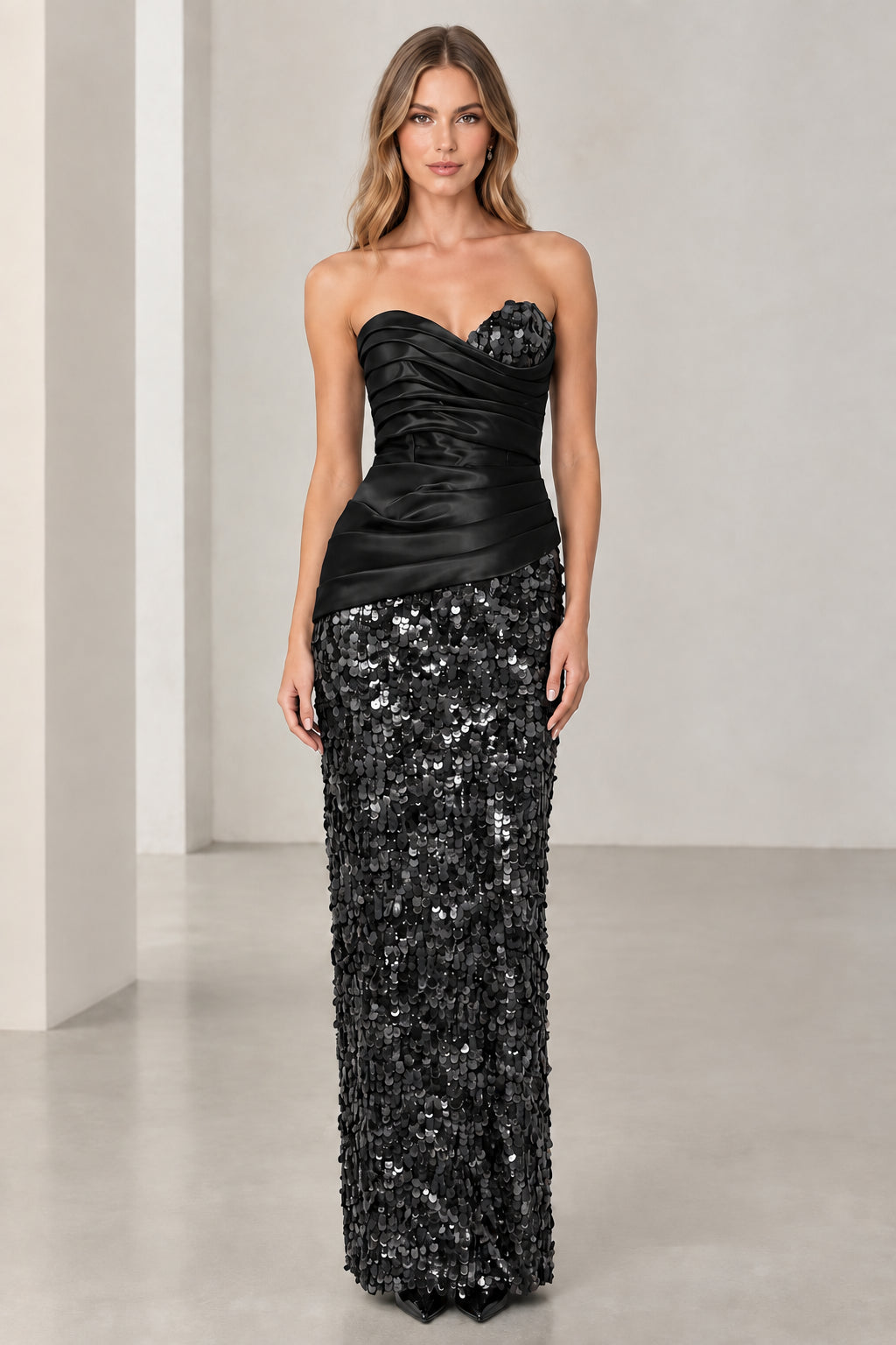 Model wearing black strapless satin and sequin column evening dress