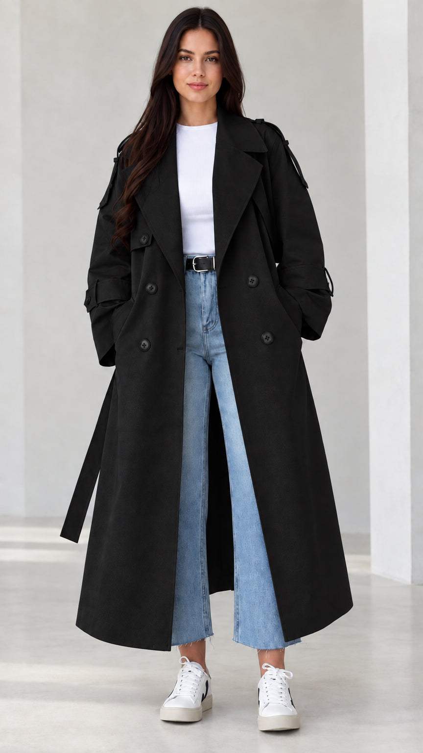 Front view of model wearing black double-breasted maxi trench coat