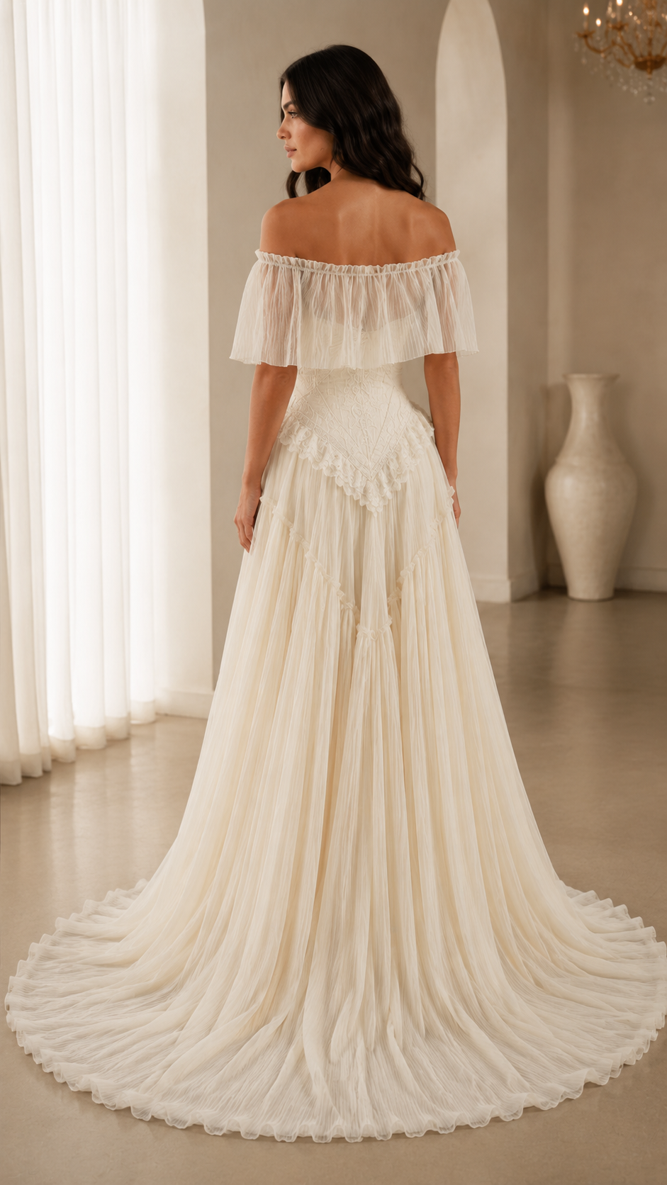 Back view of ivory off-shoulder ruffle gown showing fitted bodice and sweeping skirt