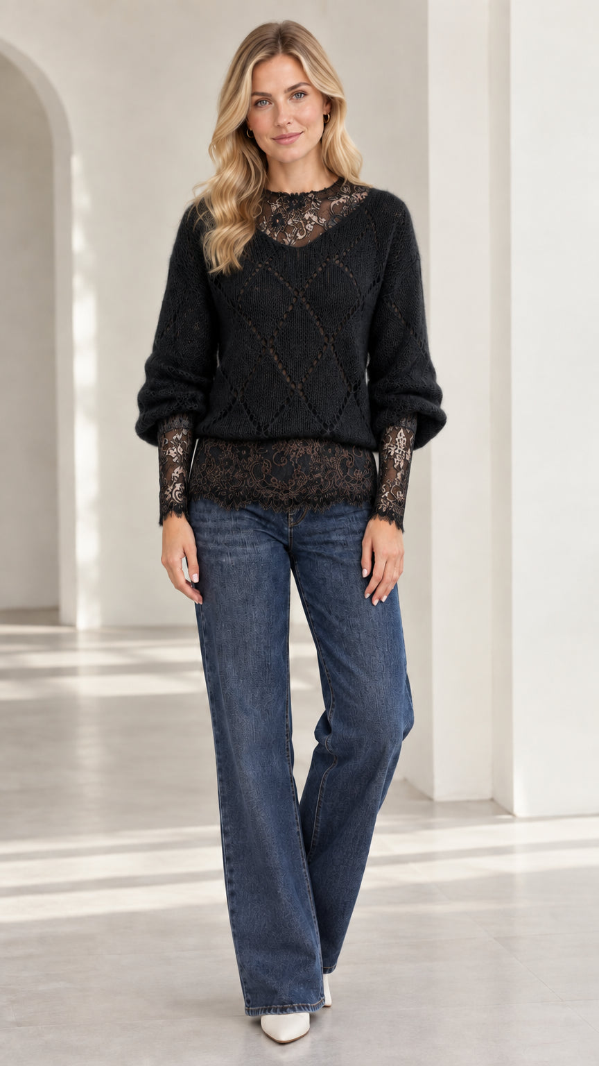 Model wearing black diamond knit sweater with black floral lace detailing