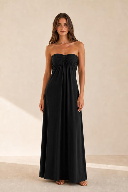 Woman wearing black strapless ruched maxi dress front view