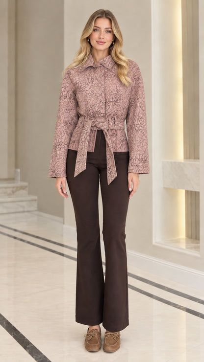 Front view of model wearing dusty rose pink textured jacquard belted jacket