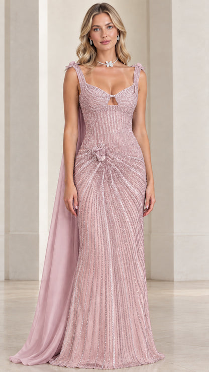 Model wearing blush pink beaded formal gown with sheer draped cape