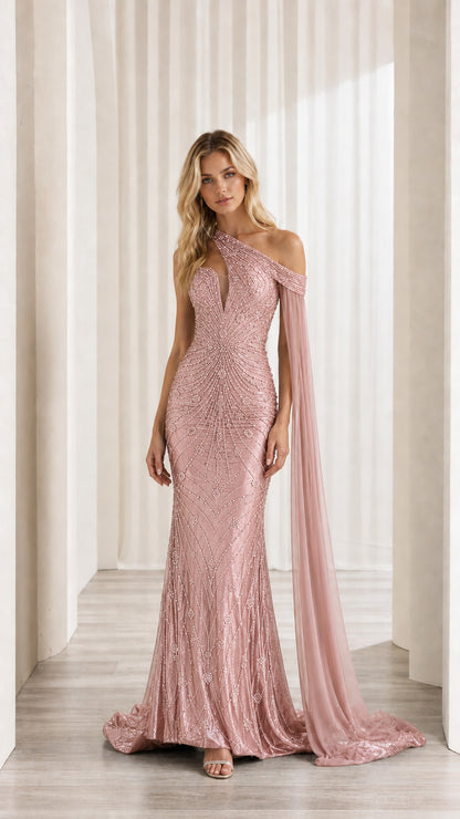 Front view of model wearing blush pink sequin one-shoulder gown with cape