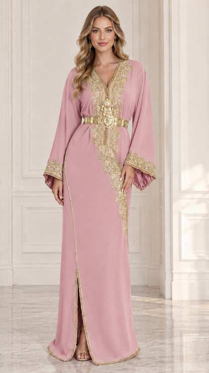 Front view of model wearing blush pink Moroccan kaftan dress with gold embroidery and belt