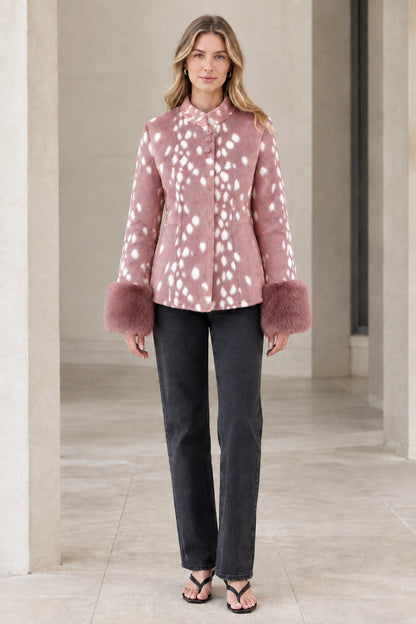 Front view of model wearing pink spotted faux fur jacket with plush cuffs