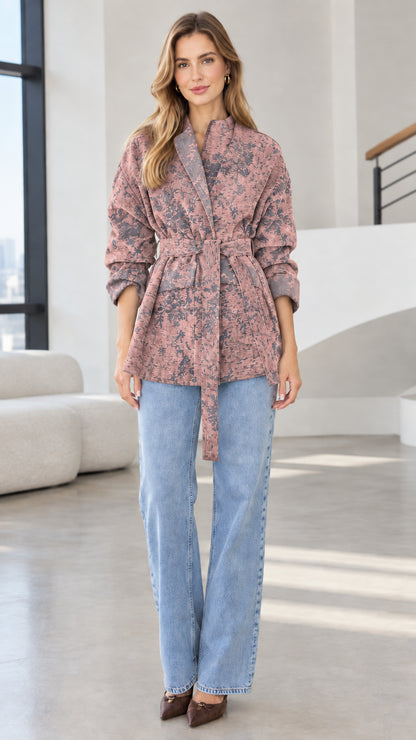 Model wearing dusty rose pink floral jacquard belted wrap jacket