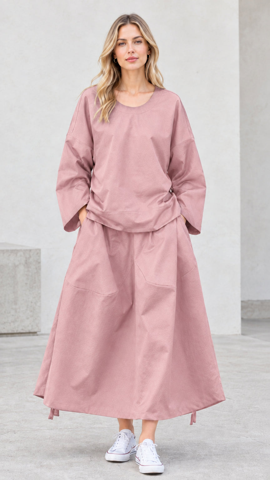 Front view of model wearing dusty pink long sleeve top and maxi skirt set