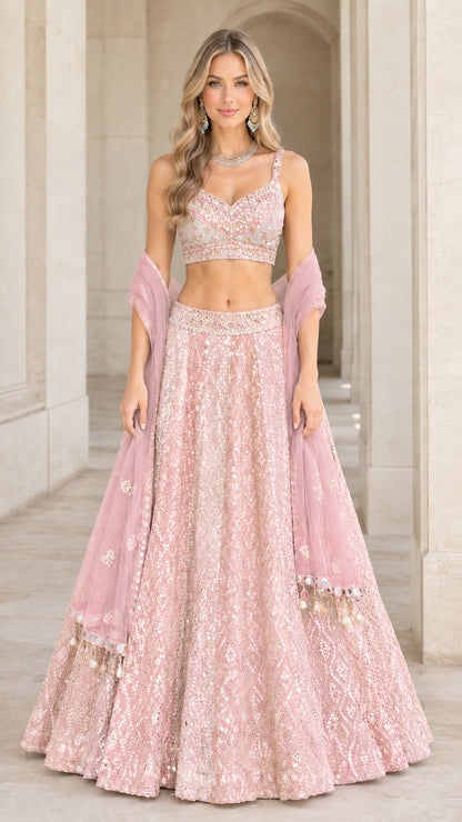 Model wearing blush pink monochrome embroidered lehenga choli set