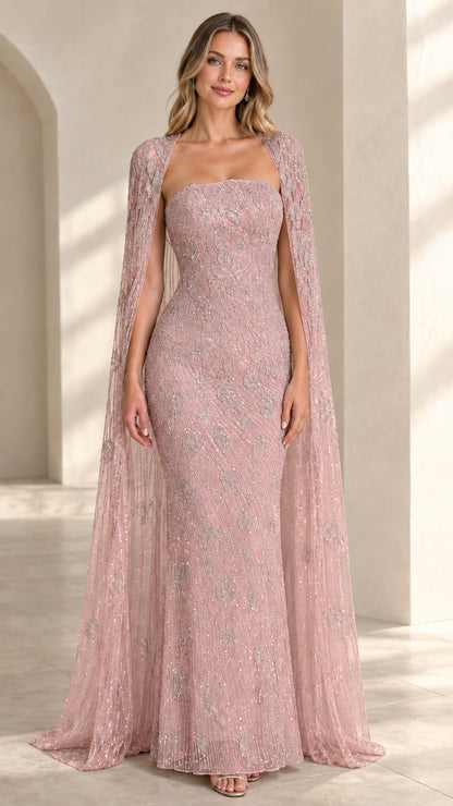 Front view of blush pink sequin strapless evening gown with flowing cape