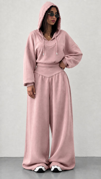 Woman wearing dusty pink 2-piece hooded sweatshirt and wide leg pants set