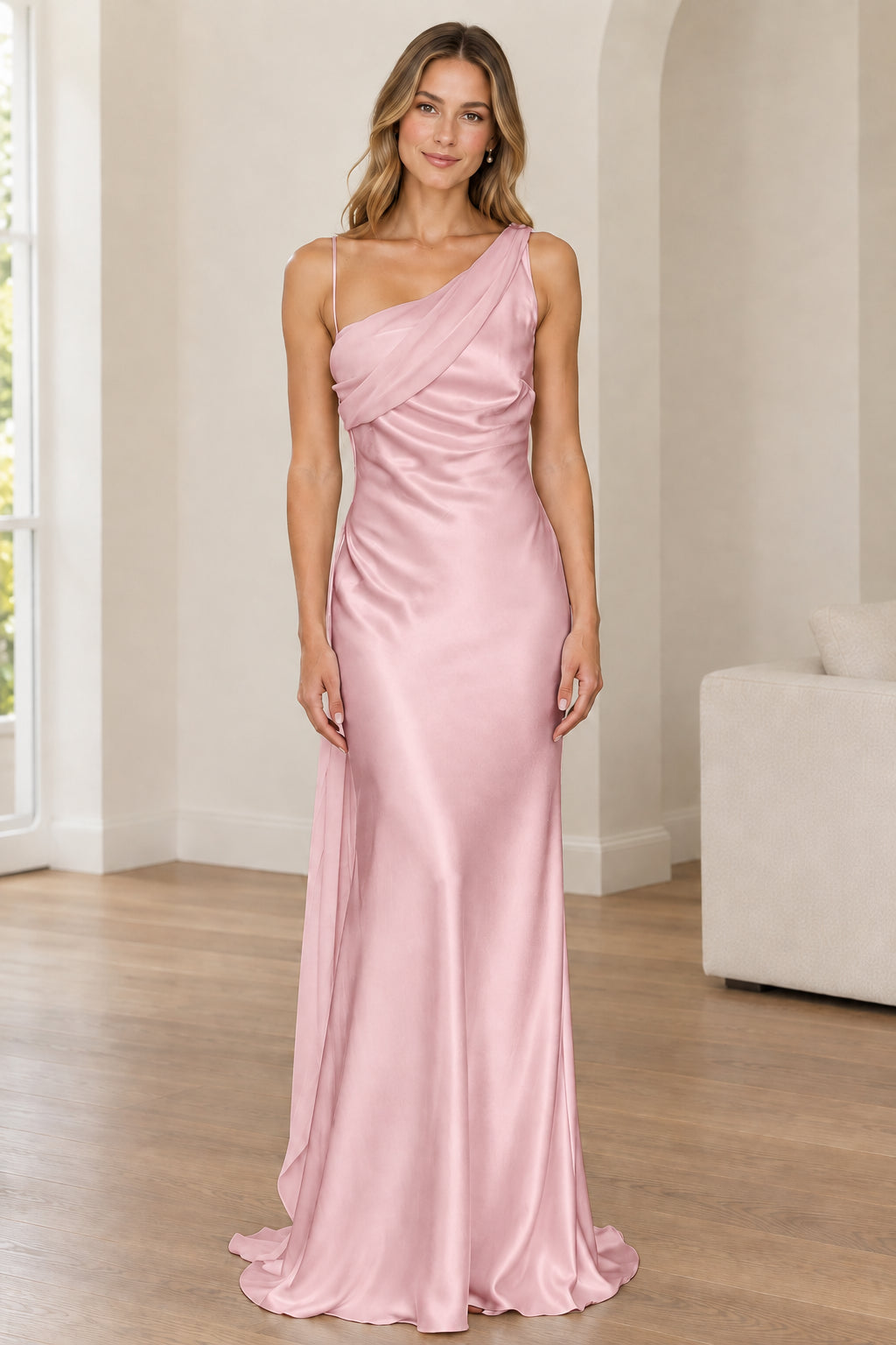 Front full-length view of woman in blush pink one-shoulder satin gown