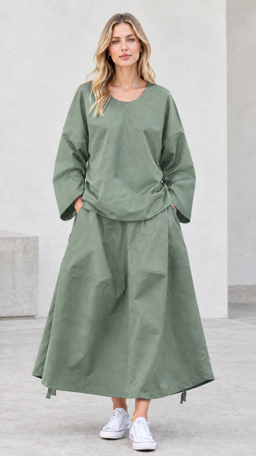 Front view of model wearing sage green relaxed two-piece skirt set