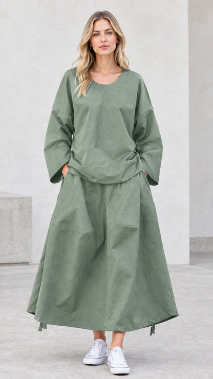 Front view of model wearing sage green relaxed two-piece skirt set