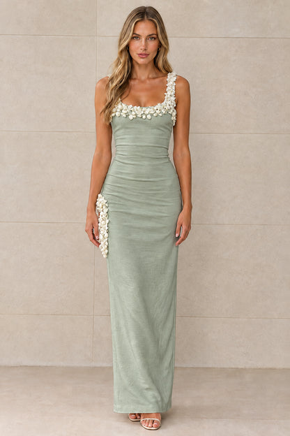 Front view of sage green sleeveless column maxi dress with white floral appliqués