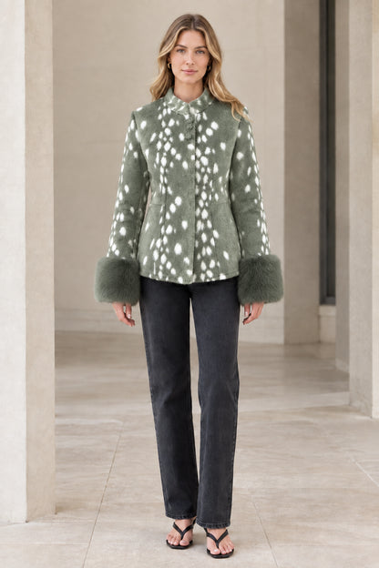 Front view of model wearing sage green spotted faux fur jacket with plush cuffs