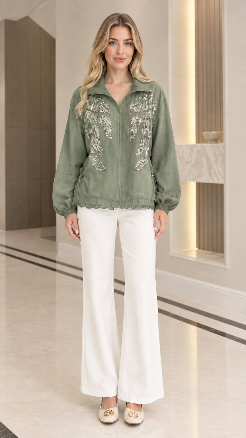 Front full-length view of woman wearing sage green sequin embroidered zip-up jacket