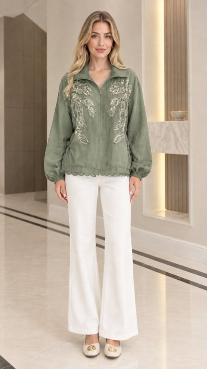 Front full-length view of woman wearing sage green sequin embroidered zip-up jacket