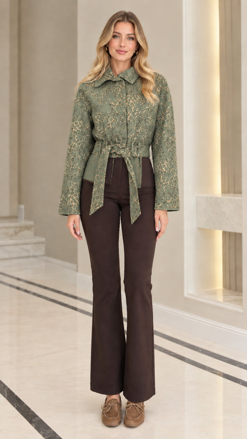 Front view of model wearing sage green textured jacquard belted jacket